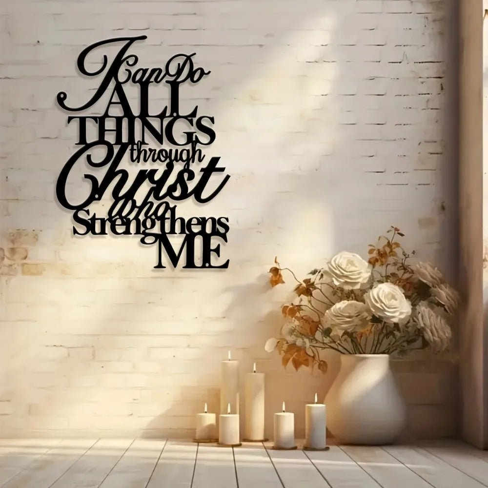 Black script wall art featuring the verse "Fan Do All Things through Christ strengthens me" displayed on a white brick wall.