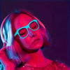 A close-up portrait of a woman wearing bright blue glow in the dark party glasses with her eyes closed.