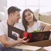 A couple smiling while looking at a vintage kraft scrapbook album for photos and memories.
