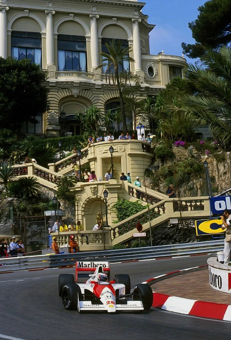 A Formula 1 race car drives on a track with a grand building in the background.