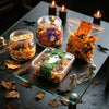 A collection of Halloween sealing stickers and decorative elements including candles, bats, skulls, and autumn leaves on a da