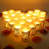 A collection of glowing LED tea light candles in ornate paper lampshades arranged on a surface.