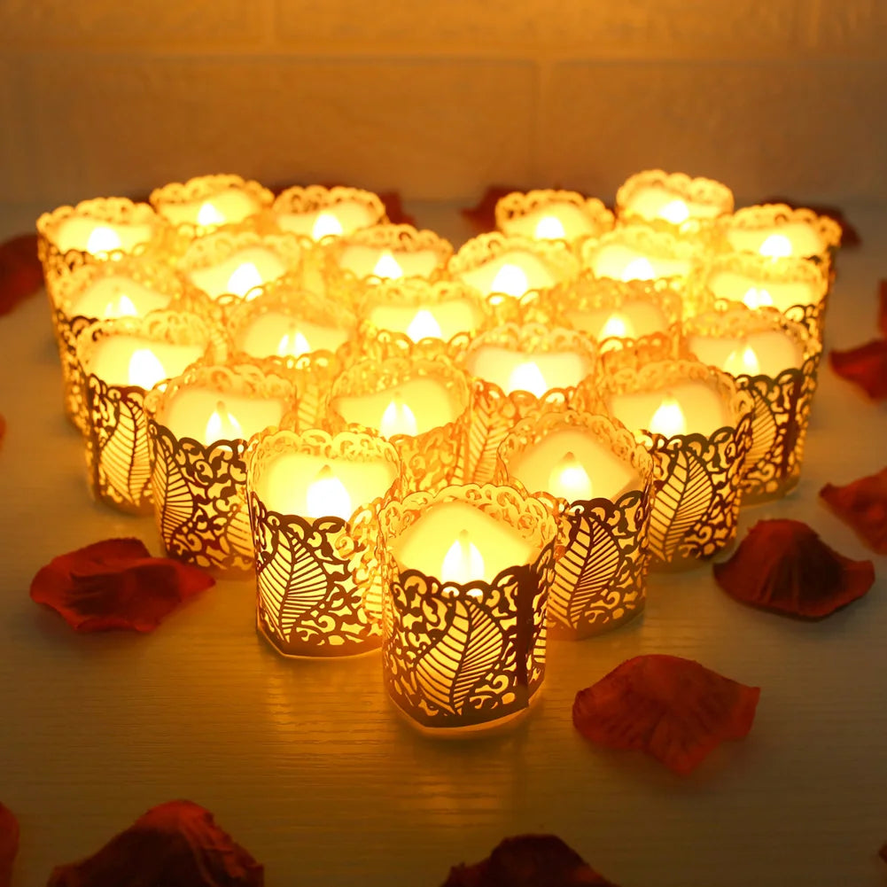 A collection of glowing LED tea light candles in ornate paper lampshades arranged on a surface.