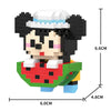A black and white animal model built from LEGO bricks, featuring a face and a green body.