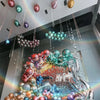 A display of chrome metallic latex balloons in various colors like gold, silver, purple, and green for party decor.