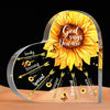 A heart-shaped glass plaque with a sunflower design and Bible verses like God says you are strong and special.