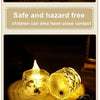 A set of glowing LED crystal candles on a wooden surface, demonstrating safe and hazard-free close contact for children.