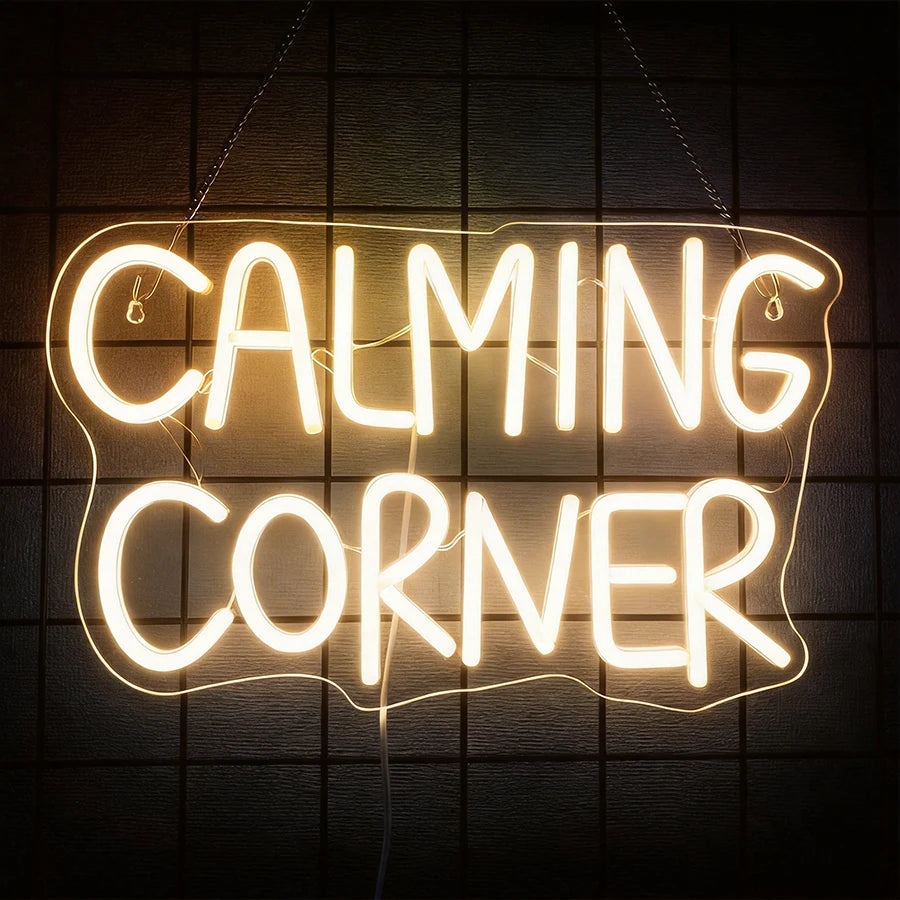 A glowing white neon sign spelling out CALMING CORNER hanging against a dark background.