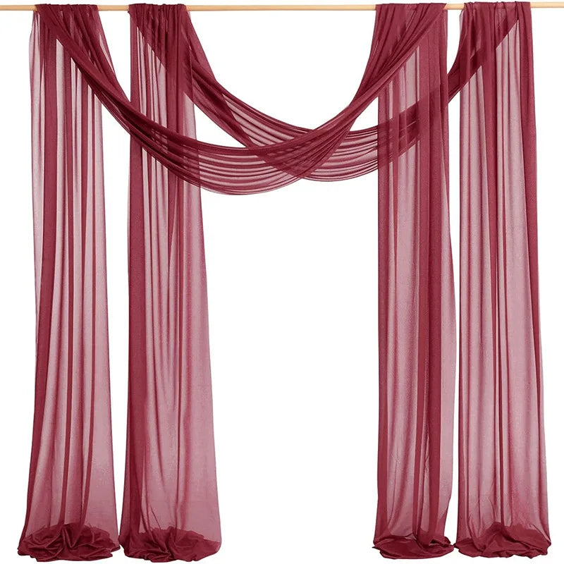 Maroon chiffon arch drapes used as a backdrop for weddings and events