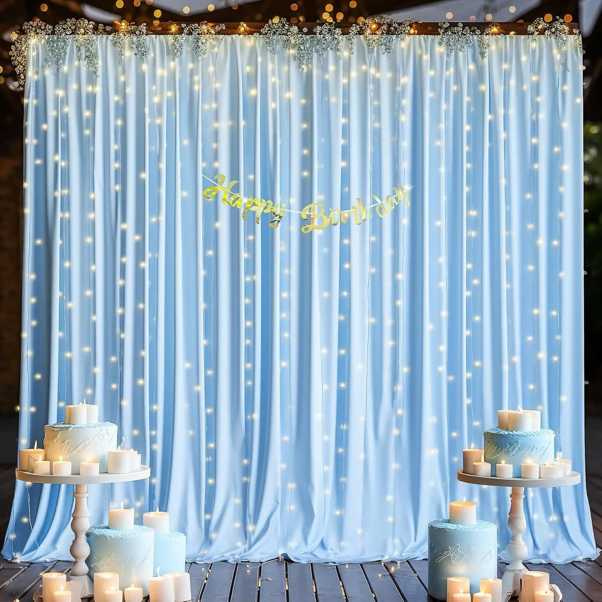Elegant blue fabric party backdrop curtains with twinkling lights and a happy birthday banner