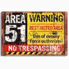 A vintage metal sign with a distressed yellow and black background warning area 51 restricted area no trespassing