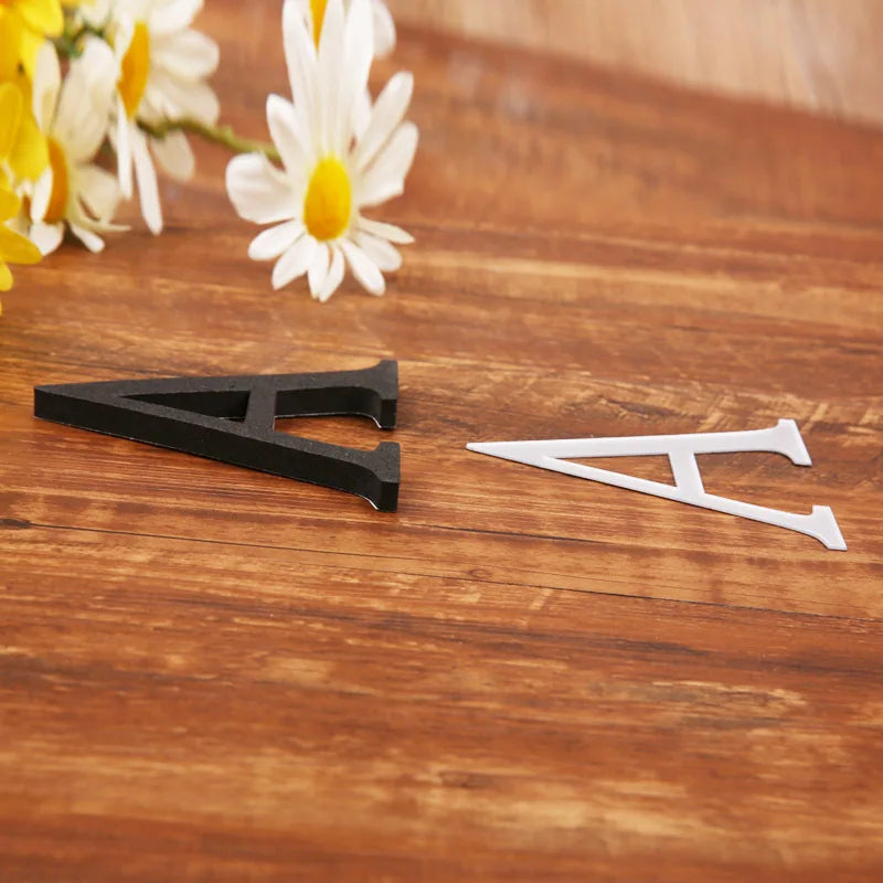 Black and white acrylic letter wall stickers shaped like the letter A on a wooden surface