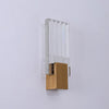 Modern bubble crystal LED wall sconce with a clear glass panel and a brass base.