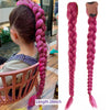 A long pink braided ponytail hairpiece with a leather tie is shown next to a child's head.