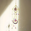 A hanging crystal sun catcher featuring a geometric gold frame and various colored gemstone drops.