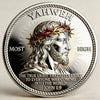 A silver challenge coin featuring a depiction of Jesus with a crown of thorns and rays of light.