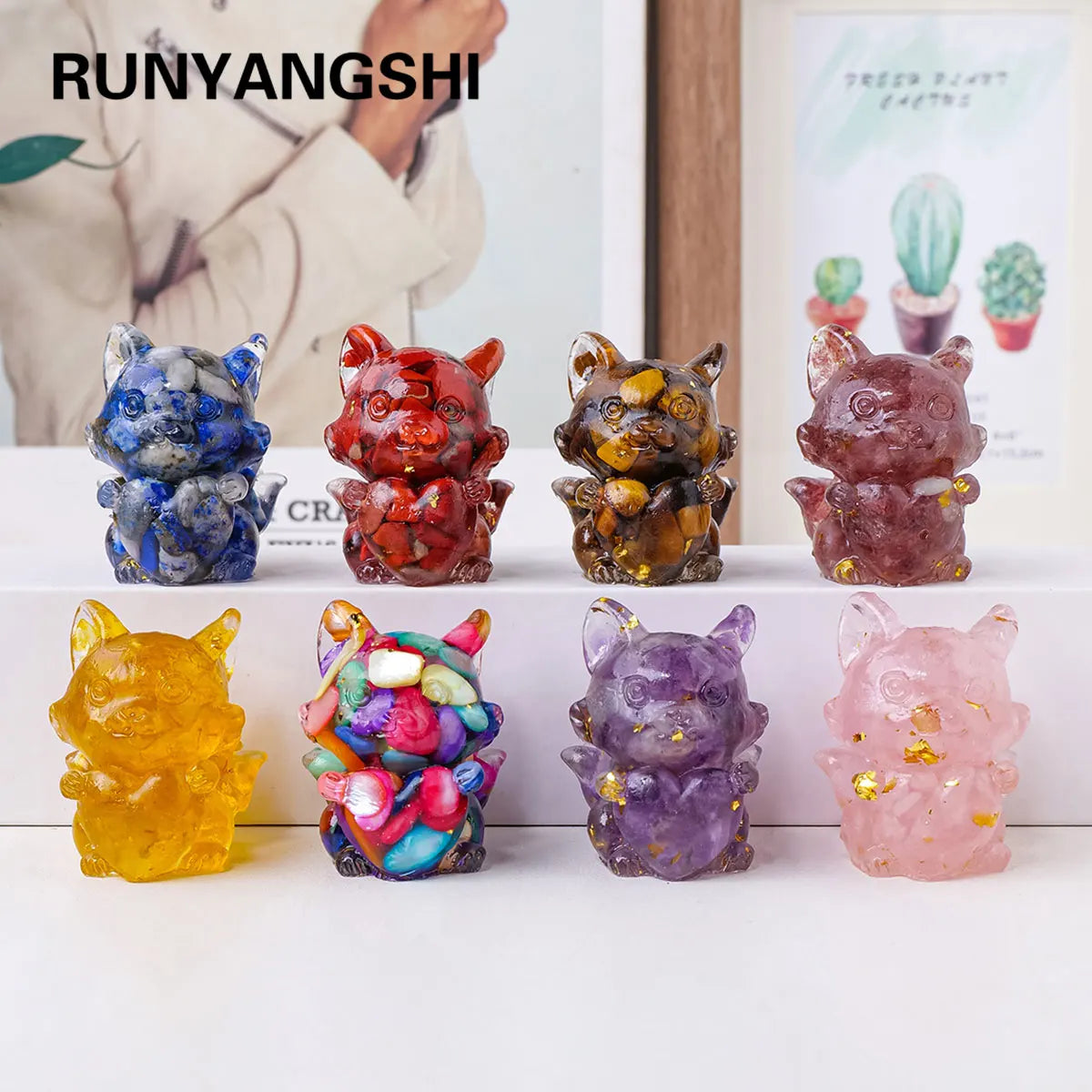 A collection of natural fox crystal sculptures in various colors and textures displayed on a white surface.