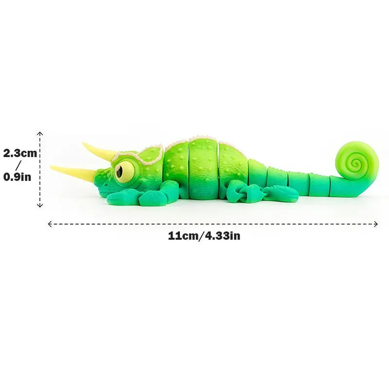A bright green chameleon fidget toy with a textured body and a coiled tail, shown next to a measurement scale.