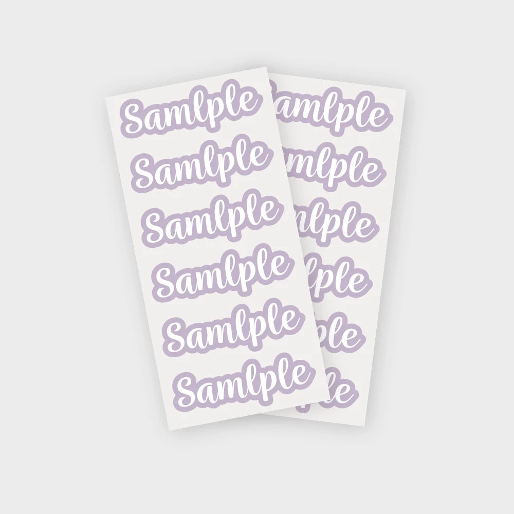 A sheet of purple personalized name stickers with the word sample repeated on each label