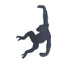 A black monkey-shaped storage hook with a banana design.