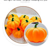 An orange decorative LED pumpkin night light with a green stem, shown in a close-up view.