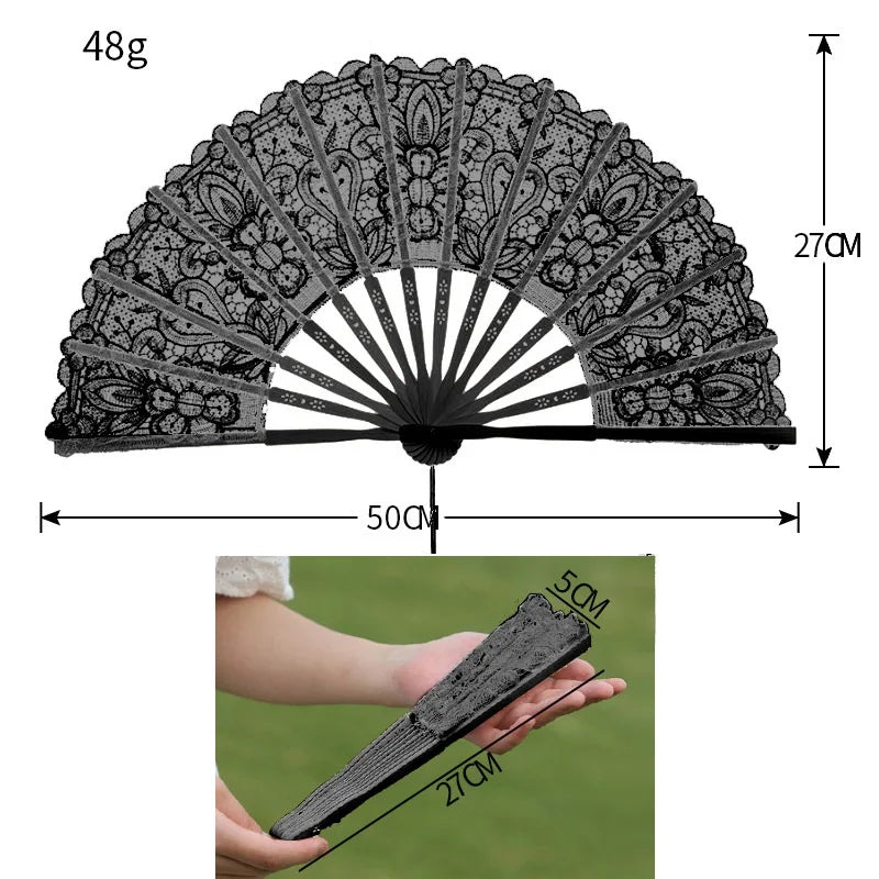 A black lace folding hand fan with a 48g weight, shown in an open fan and held by a hand.