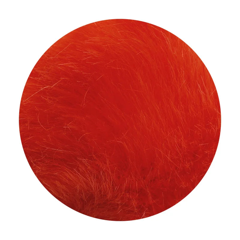 A round, vibrant red pom pom made of faux fur with a silver chain.