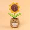 Handmade crochet sunflower desk companion with a smiling face made of yarn.