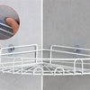 White wire mesh wall hooks installed on a gray wall, demonstrating strong adhesive mounting.