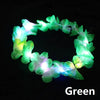 A green LED flower crown headband with glowing lights against a black background.