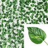 Green artificial ivy vine garland covering a white background