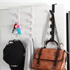 Over-the-door hooks displaying a black hat, a brown leather bag, and various accessories on a white door.