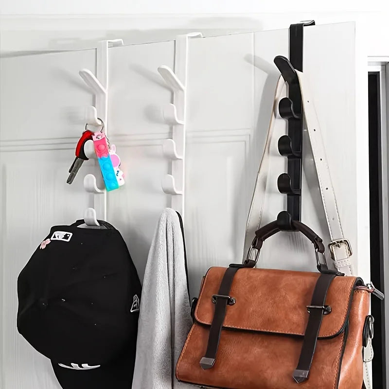 Over-the-door hooks displaying a black hat, a brown leather bag, and various accessories on a white door.
