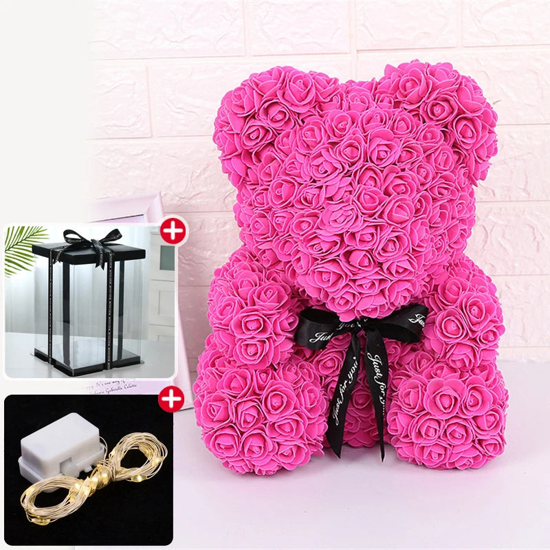 Un ours rose et moelleux en forme de rose avec un ruban noir et une décoration lumineuse LED.