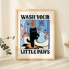 A framed poster featuring a cartoon black cat washing its paws in a bathtub, with the text Wash Your Little Paws.