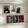 A collection of movie posters featuring Patrick Bateman and other characters displayed on a light wood shelf.