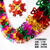 A colorful tinsel garland ribbon featuring red, green, and gold shimmer for holiday decoration.