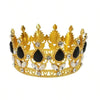 A golden crown made of crystal and black stones used as a cake topper.