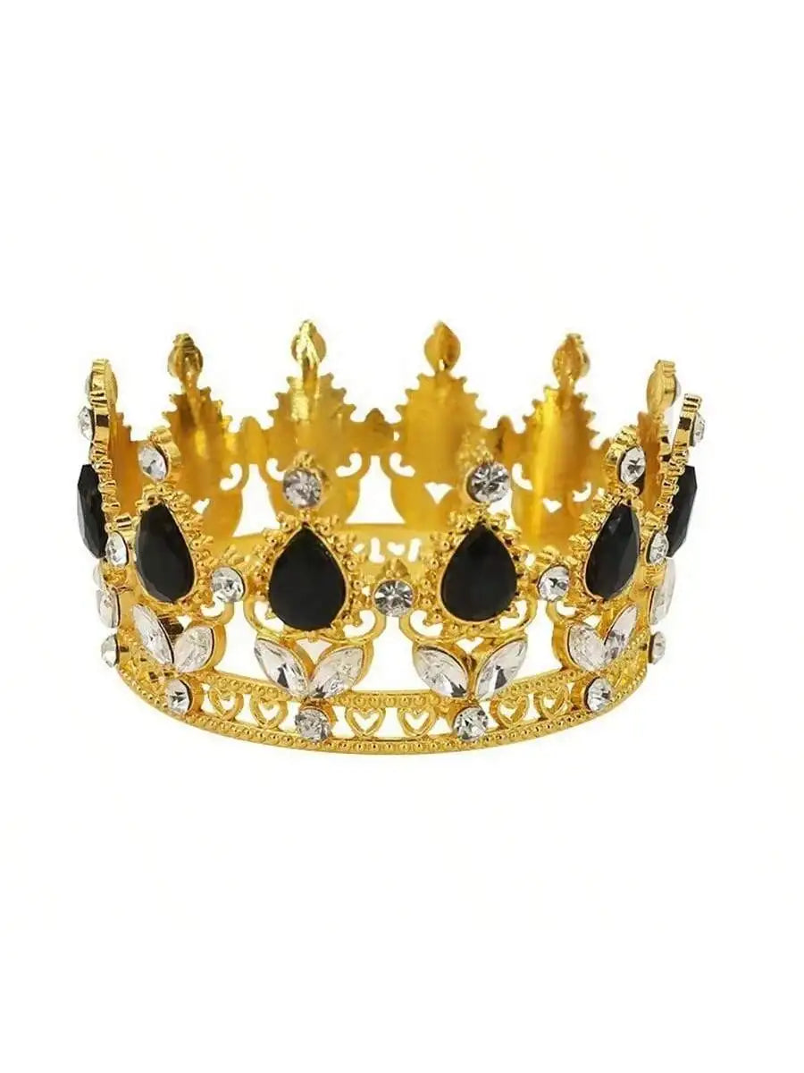 A golden crown made of crystal and black stones used as a cake topper.