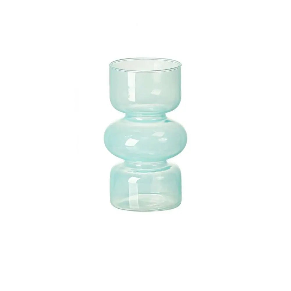 A light blue, round glass flower vase with a wide mouth and a pedestal base.