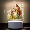 A 3D LED night light depicting Jesus and a child in a natural setting.