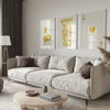 A modern living room features a light sofa and wooden coffee table with a framed lucky letter art canvas set on the wall.