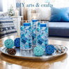 A collection of decorative acrylic ice rocks in various shades of blue and teal displayed on a silver tray.