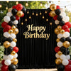 A festive birthday backdrop decorated with balloons in gold, black, and white colors.