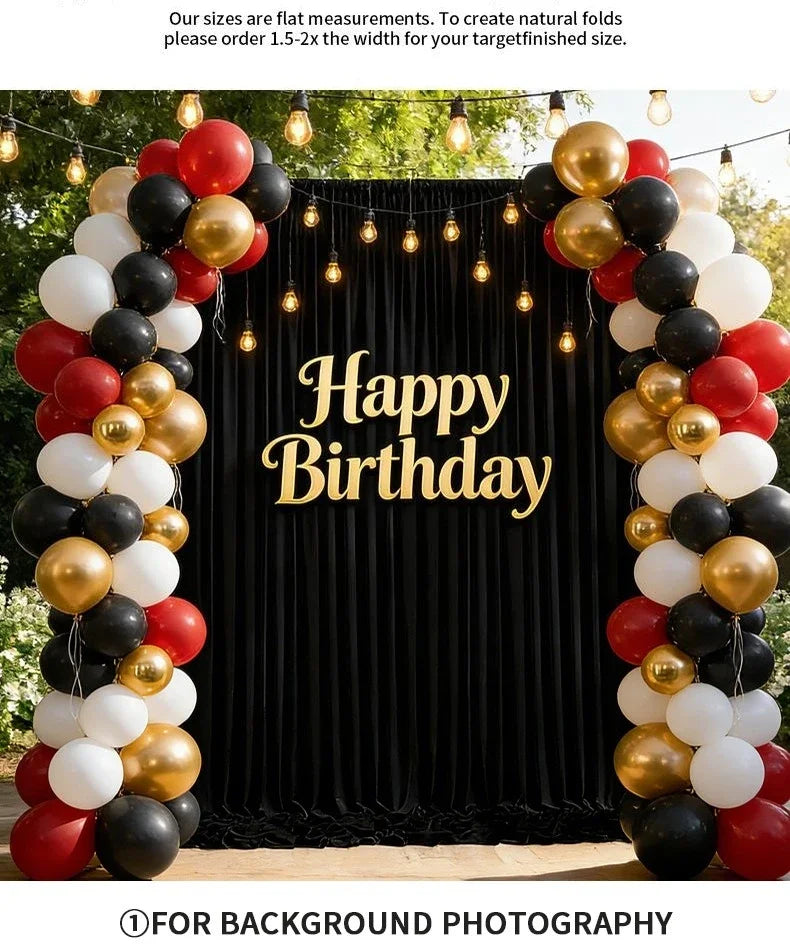 A festive birthday backdrop decorated with balloons in gold, black, and white colors.