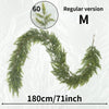 A long, arched garland made of green cedar branches, labeled as the Regular version M.
