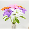 Hand-crocheted artificial lily bouquet featuring purple, white, and orange flowers on green stems