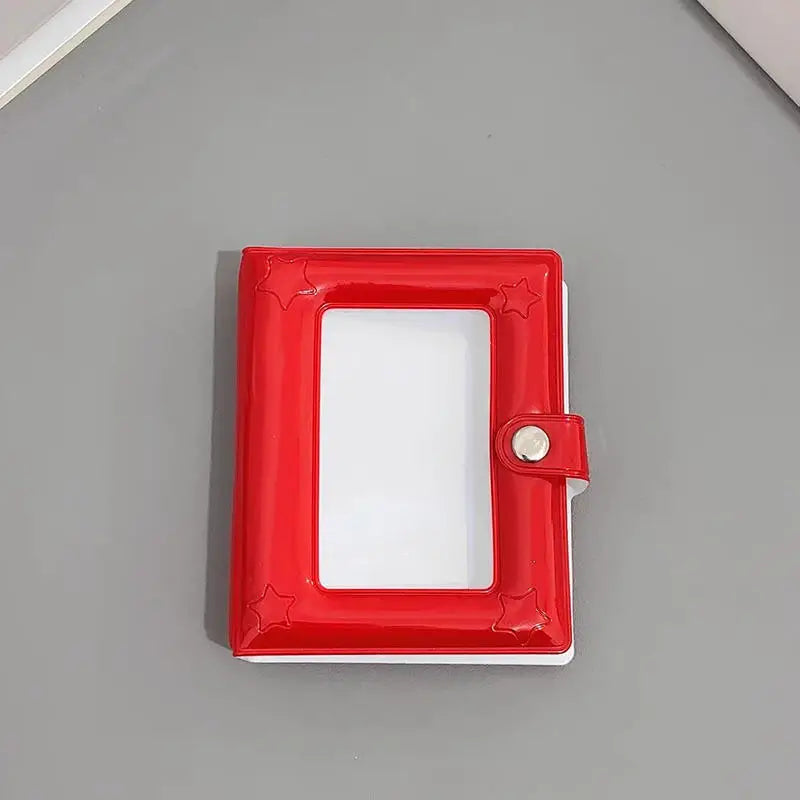 A red mini photo card binder with a white interior and a silver clasp.