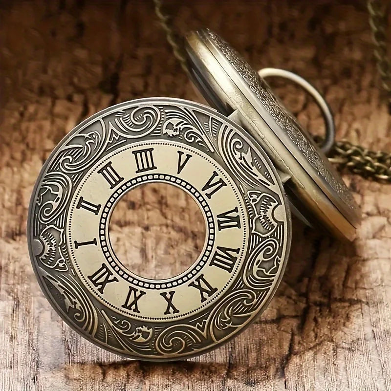 A vintage bronze quartz pocket watch with an ornate dial and chain resting on a wooden surface.