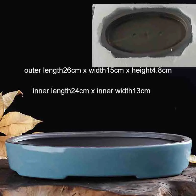 A light blue glazed ceramic bonsai flower pot with a wide rim and a slightly flared base.